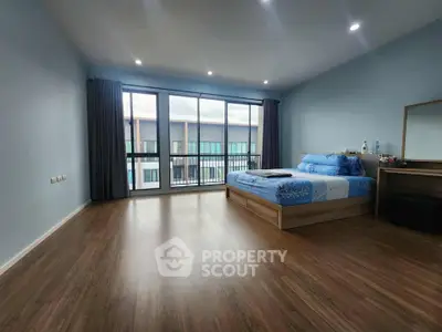 Spacious bedroom with large windows and modern decor