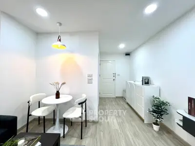 Modern minimalist living room with white furniture and wood flooring