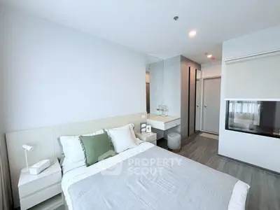 Modern bedroom with sleek design, featuring a cozy bed and stylish decor in a contemporary apartment.