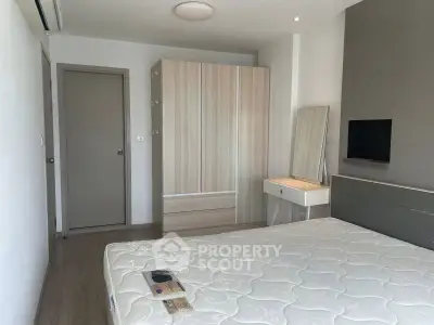 Modern bedroom with sleek wardrobe and minimalist decor, perfect for urban living.