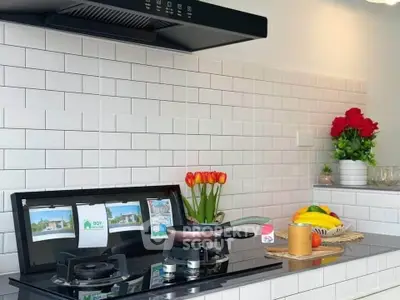 Modern kitchen with sleek gas stove and stylish white subway tiles