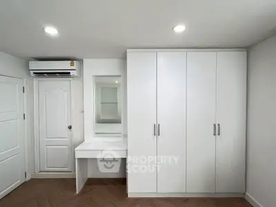 Modern bedroom with built-in wardrobe and vanity in minimalist design