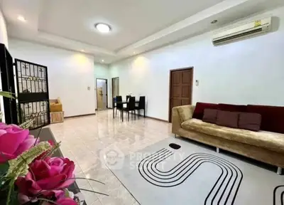 Spacious living room with modern decor and elegant dining area