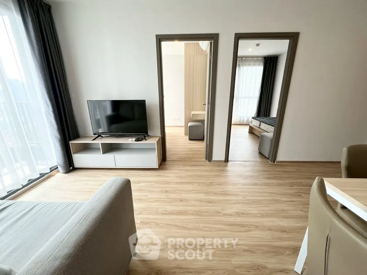 Modern living room with wooden flooring and natural light
