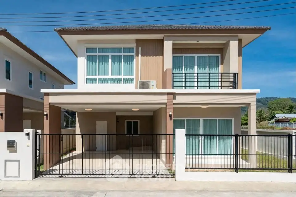 Modern two-story house with large windows and gated driveway in a suburban neighborhood.