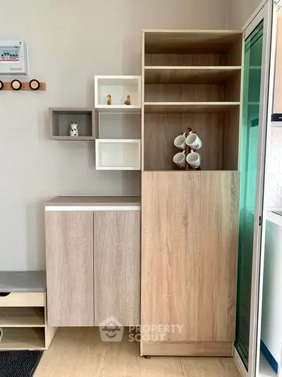 Modern interior with stylish wooden cabinets and decorative shelving in a cozy living space.