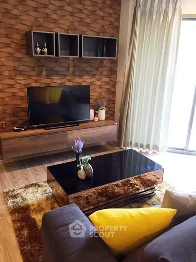 Stylish living room with modern decor, featuring a sleek TV stand, cozy sofa, and elegant coffee table.