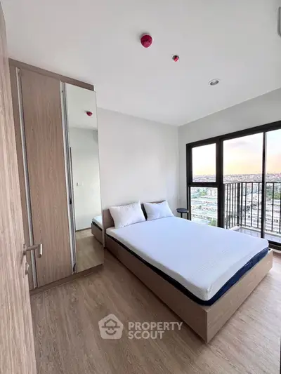 Modern bedroom with city view and sleek wooden furniture