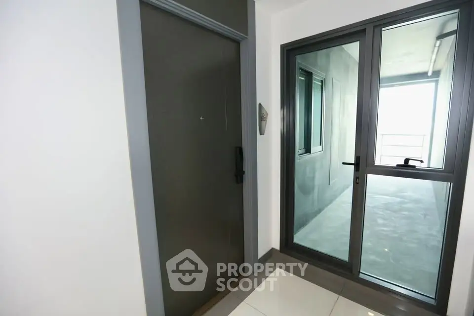 Modern apartment entrance with sleek door and large window