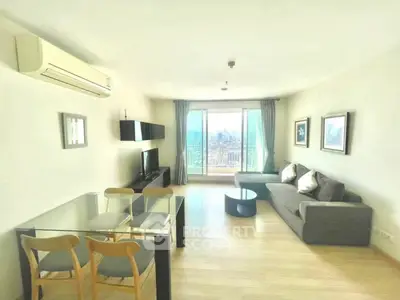 Spacious living room with city view, modern furniture, and natural light.