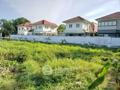 Charming suburban homes with lush green lawns and clear blue sky.