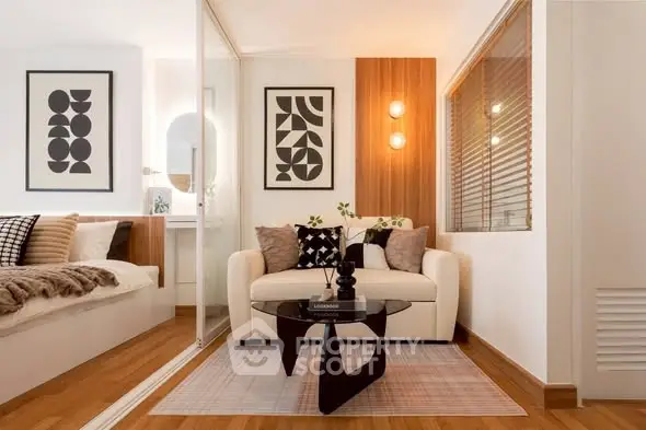 Stylish modern living room with cozy seating and elegant decor in a contemporary apartment.