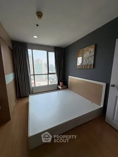 Spacious bedroom with city view and modern decor