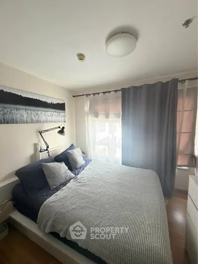 Cozy bedroom with modern decor and ample natural light, featuring a comfortable bed and stylish curtains.