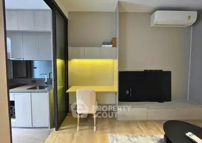 Modern apartment interior with study area and compact kitchen