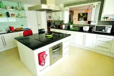 Spacious modern kitchen with island and sleek appliances in a stylish home.