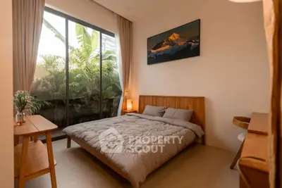 Cozy bedroom with large window and garden view, featuring wooden furniture and warm lighting.