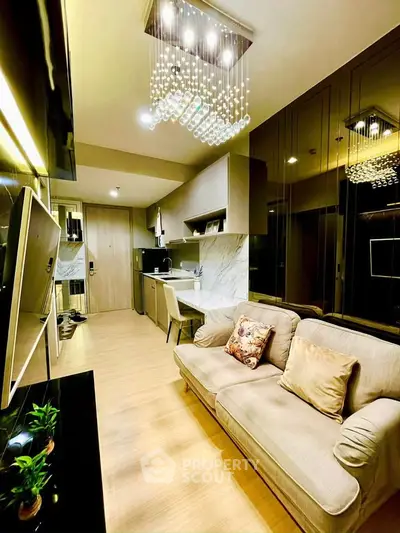 Modern living room with elegant lighting and cozy seating in a stylish apartment.