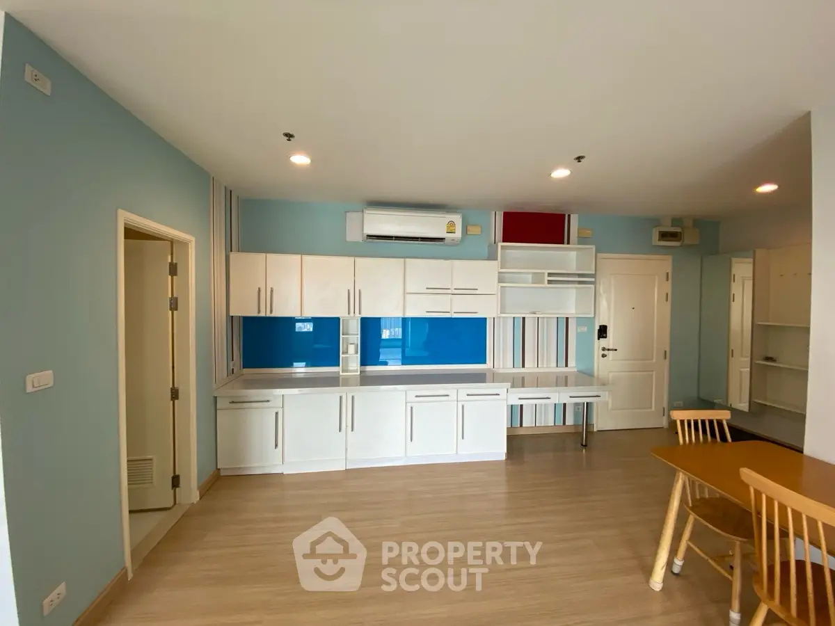 Spacious modern living room with built-in storage and dining area