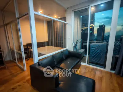 Modern apartment with glass walls and city view at sunset
