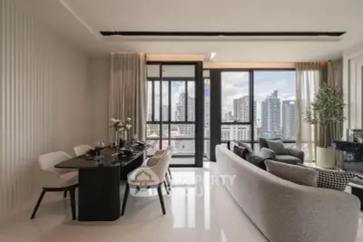 Luxurious modern living room with city view, elegant dining area, and stylish decor in high-rise apartment.