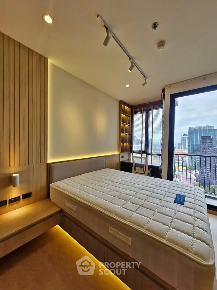 Luxurious bedroom with city view and modern lighting in high-rise apartment