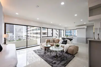 Spacious modern living room with large windows and city view