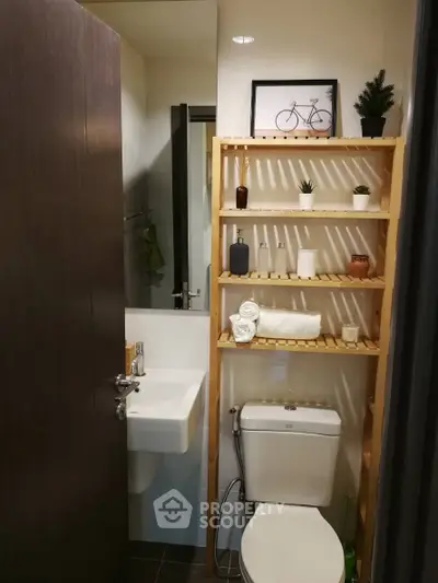 Compact modern bathroom with wooden shelving and minimalist decor