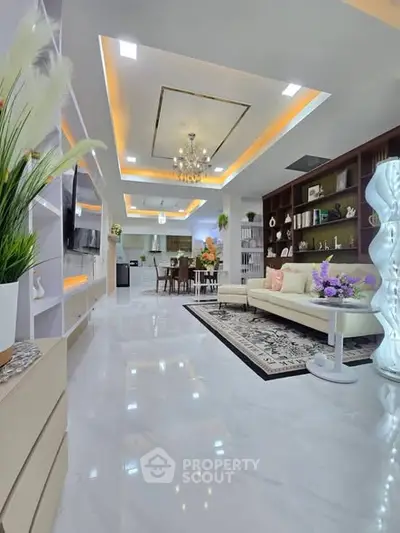 Luxurious open-plan living room with elegant decor and modern lighting