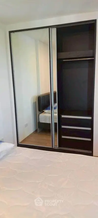 Modern bedroom with mirrored wardrobe and stylish bed frame
