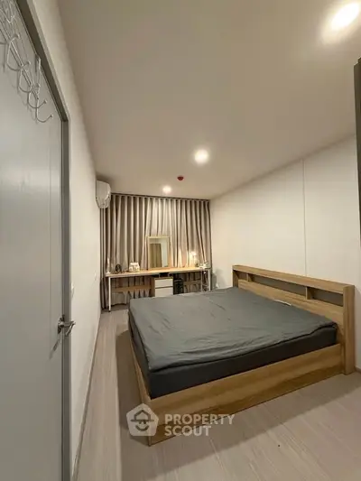Modern minimalist bedroom with wooden bed frame and sleek decor