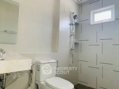 Modern bathroom with sleek fixtures and natural light, perfect for a contemporary home.