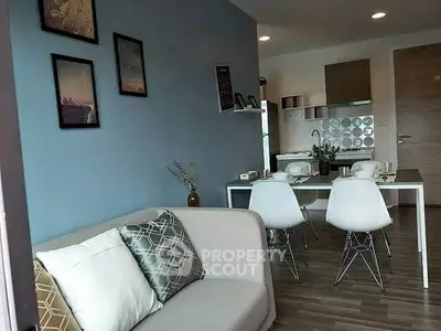 Modern living room with stylish decor and dining area in open layout apartment.