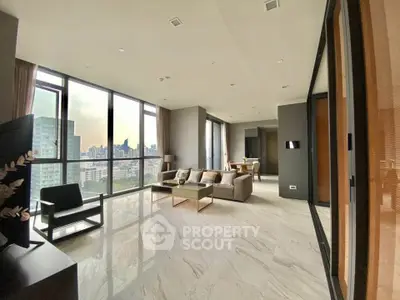 Luxurious corner unit living room with panoramic city views and elegant marble flooring.