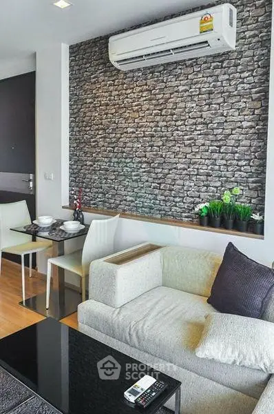 Modern living room with stylish brick accent wall and cozy seating area