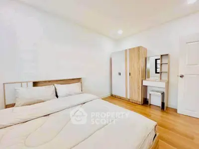 Bright and cozy bedroom with modern furniture and wooden flooring