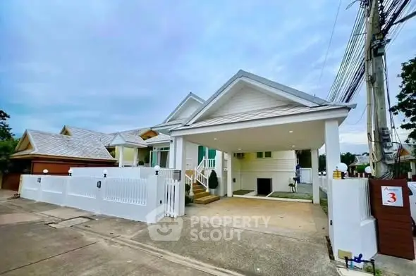 Charming suburban home with spacious driveway and modern exterior design.