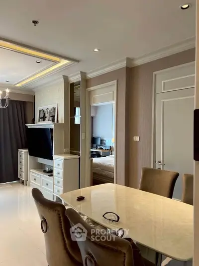 Elegant living room with dining area, featuring modern decor and a cozy ambiance.