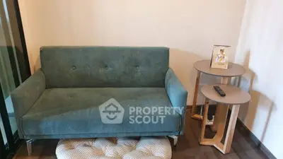 Cozy living room with modern teal sofa and stylish side tables