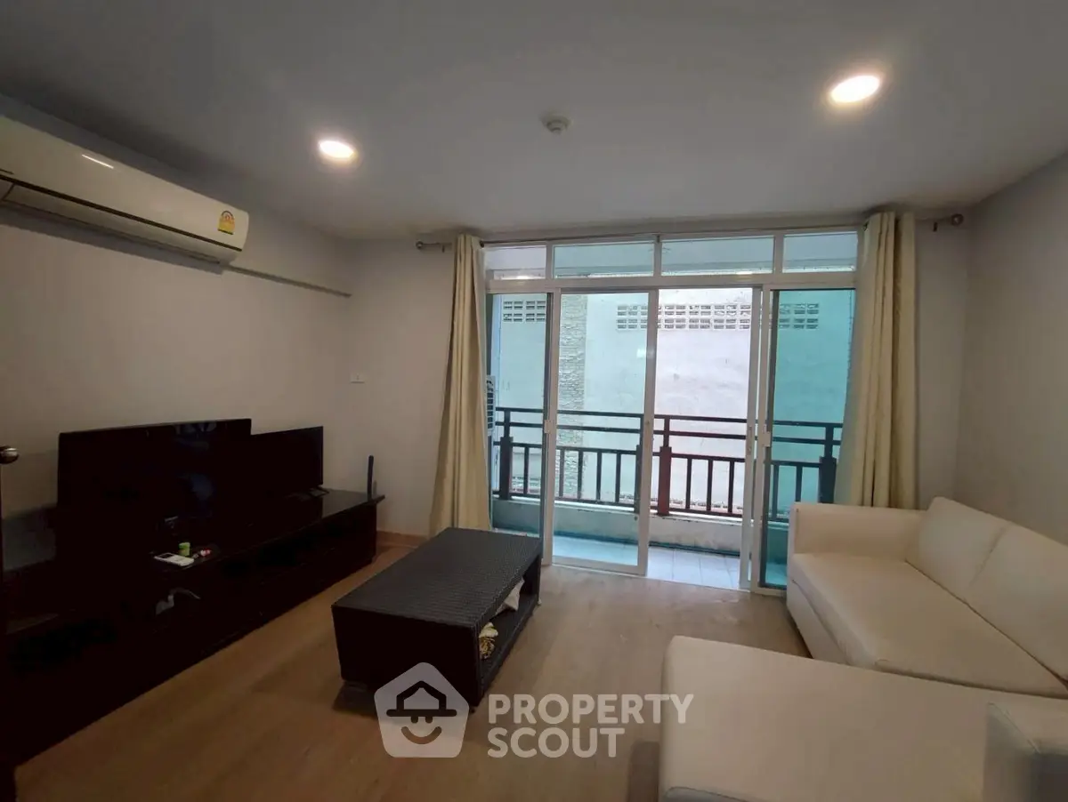 Modern living room with balcony access and sleek furniture