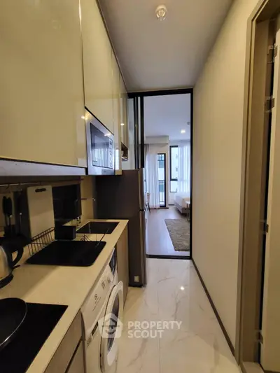 Modern apartment with sleek kitchen and cozy bedroom view