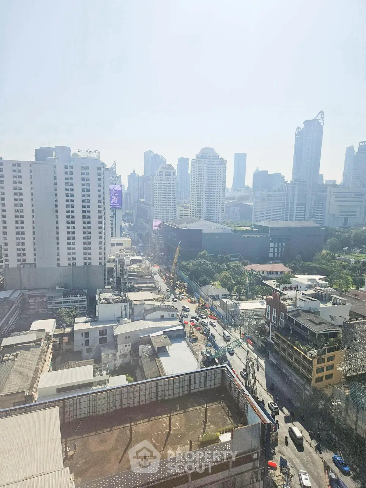Stunning cityscape view from high-rise building showcasing urban skyline and bustling streets below.