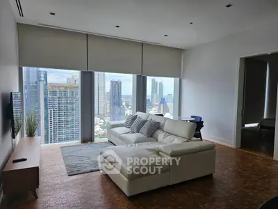Spacious modern living room with stunning city view and elegant white sofa.