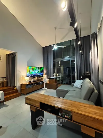 Spacious modern living room with high ceiling and stylish furniture