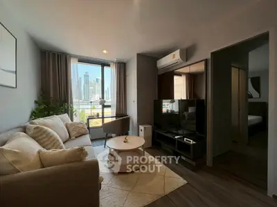 Modern living room with city view, cozy sofa, and stylish decor