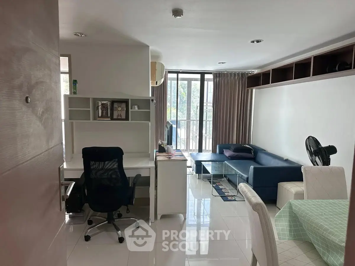 Modern living room with study area and large windows in a stylish apartment
