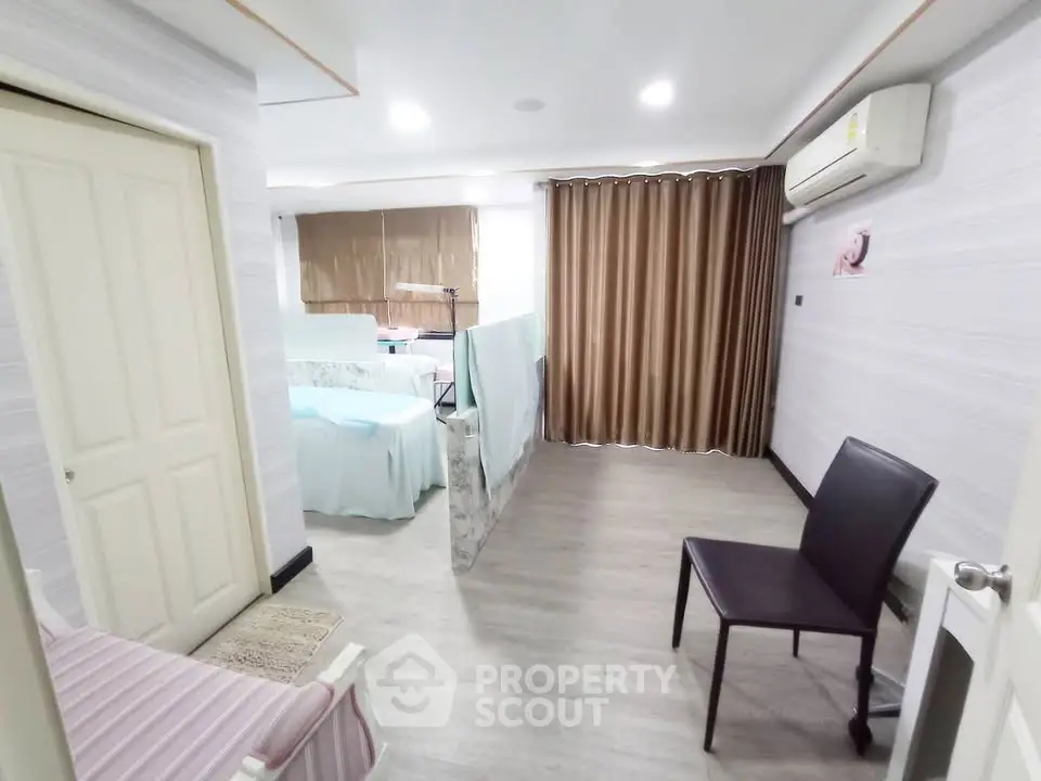 Spacious living area with modern decor and air conditioning in a stylish apartment.