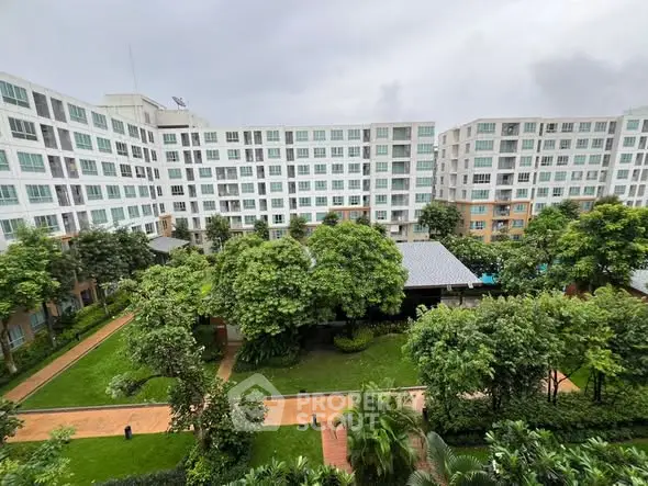 Spacious apartment complex with lush green gardens and modern architecture.