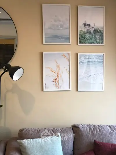 Cozy living room with stylish wall art and comfortable sofa, perfect for relaxation.