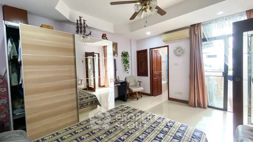 Spacious bedroom with balcony access and elegant decor